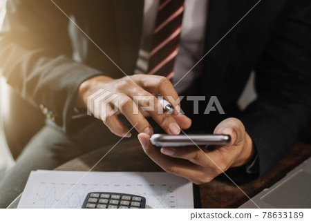 Businessman working with smart phone and laptop and digital tablet computer at home office. Businessman working with smart phone and laptop and digital tablet computer at home office. 78633189