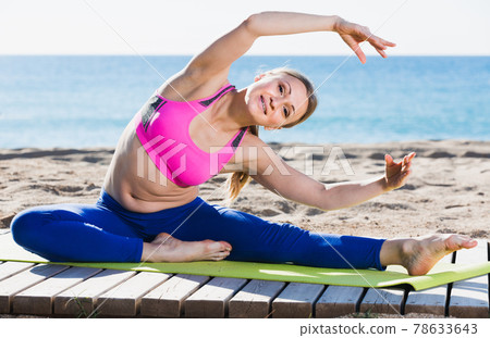 Cheerful healthy female stretching muscles 78633643