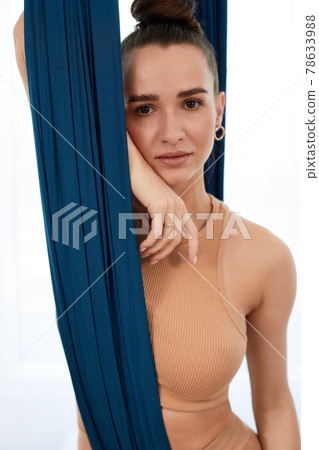 Aerial hammocks, portrait of a beautiful girl close-up, aero yoga, pilates, copy space, healthy lifestyle. 78633988
