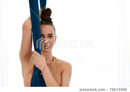 Aerial hammocks, portrait of a beautiful girl close-up, aero yoga, pilates, copy space, healthy lifestyle. 78633990