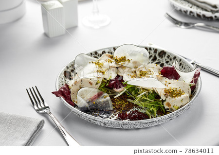 Vitello tonnato, close-up, light background. Classic Italian appetizer made from thinly sliced marinated veal slices, seasoned with cream sauce 78634011