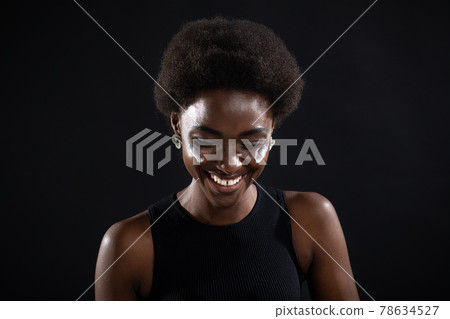 Beautiful young ethnic african american black woman applying moisturizer white cream on her face Beautiful young ethnic african american black woman applying moisturizer white cream on her face 78634527