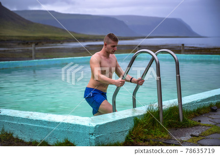 Boy gets out of the Reykjafjardarlaug Hot Pool in the Westfjords, Iceland Boy gets out of the Reykjafjardarlaug Hot Pool in the Westfjords, Iceland 78635719