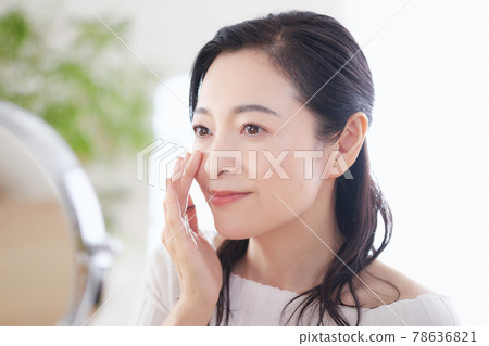 Middle-aged woman doing skin care 78636821