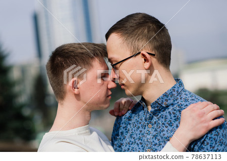 Gay couple walking in city centre, lifestyle Gay couple walking in city centre, lifestyle 78637113