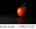 single tomato with dark background and diffuse reflection 78637187