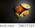 Avocado lime tomato on a black plate guacamole  78637189