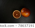 wide shot of blood orange on a black plate  78637191