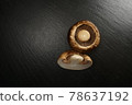 Brown button mushroom on a black plate 78637192