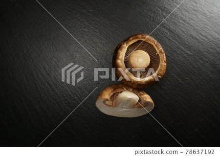 Brown button mushroom on a black plate 78637192