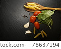 Italian pasta dish ingredients mushroom tomato basil garlic  pepper wooden spoon 78637194