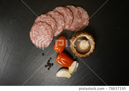 Italian pizza ingredients tomato basil garlic mushroom salami 78637195