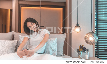 Stretch oneself, Beautiful Asian woman waking up in the morning in her modern bedroom in her new home, Wake up to a bright and comfortable morning in a luxurious room, Refreshing body, Sleep well. 78638307