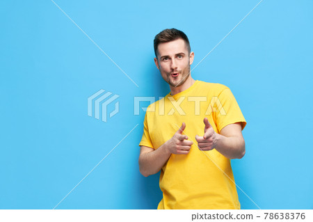 Funny joyful man pointing at you and looking to camera on blue background 78638376