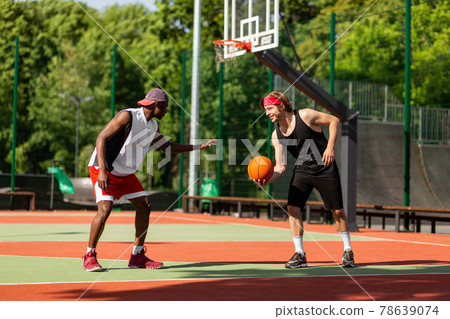 Professional basketball players having friendly match at outdoor arena Professional basketball players having friendly match at outdoor arena 78639074
