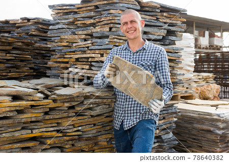 Buyer selects facing stone at an open-air construction site Buyer selects facing stone at an open-air construction site 78640382