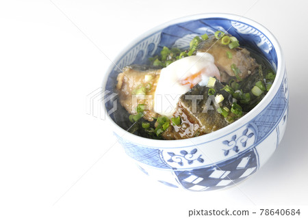Photographed a hot yellowtail teriyaki rice bowl topped with hot balls and plenty of small onions on a white background 78640684