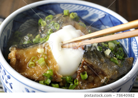Eat a hot yellowtail teriyaki rice bowl with hot balls on it 78640982