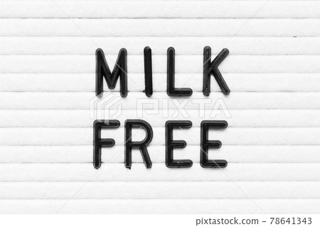 Black alphabet letter in word milk free on white felt board background Black alphabet letter in word milk free on white felt board background 78641343