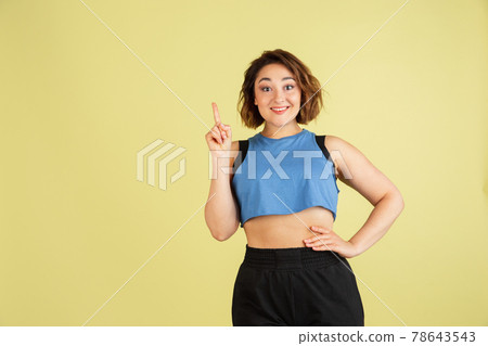 Portrait of young Caucasian beautiful woman in casual clothes isolated on light yellow background. Portrait of young Caucasian beautiful woman in casual clothes isolated on light yellow background. 78643543