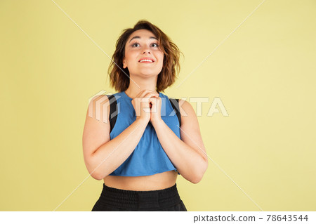 Portrait of young Caucasian beautiful woman in casual clothes isolated on light yellow background. Portrait of young Caucasian beautiful woman in casual clothes isolated on light yellow background. 78643544