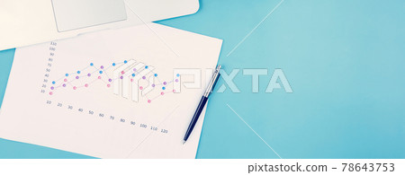 Laptop computer and documents report statistic financial with graph and chart and potted tree. 78643753