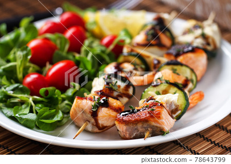Fish skewers with mixed salad. High quality photo. 78643799