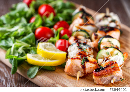 Fish skewers with mixed salad. High quality photo. 78644401