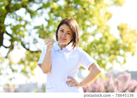 一個女人對一個擺出膽量姿勢的醫務人員 一個女人對一個擺出膽量姿勢的醫務人員 78645136