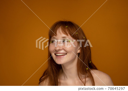 Romantic girl with green flowers at the hair and face 78645297