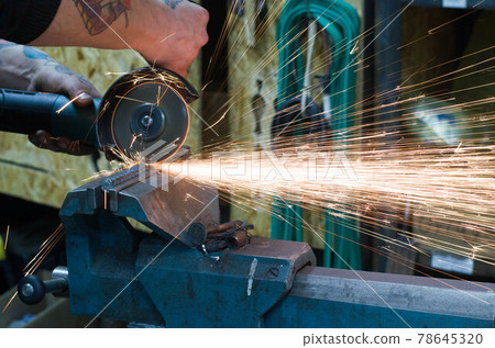 Metal cutting by grinding machine. Sparks when cutting metal. Metal cutting by grinding machine. Sparks when cutting metal. 78645320