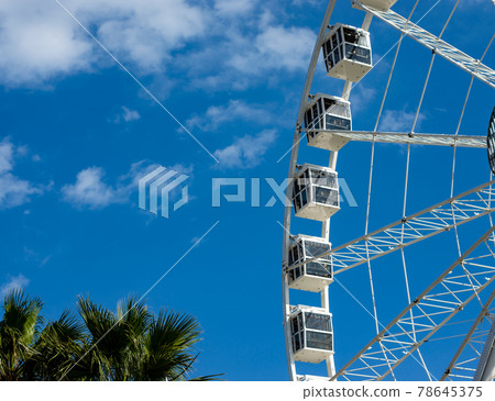Ferris wheel in a sunny day with withe clouds Ferris wheel in a sunny day with withe clouds 78645375