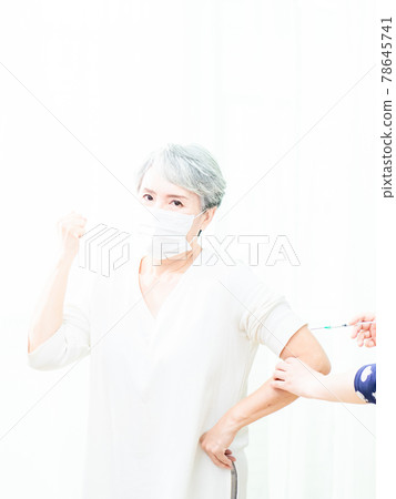 Senior asian woman receiving the injection of the coronavirus vaccine by a doctor to receive the antibodies, immunize the population. 78645741