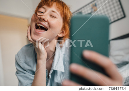 Woman taking self-portrait picture of herself in own house 78645784