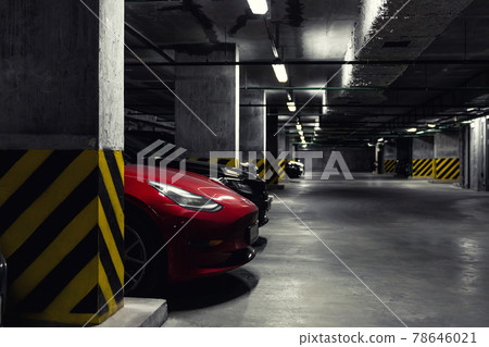 Dark scenic car park underground multilevel garage interior. Concrete cement column covered building basement floor electric vehicle parking lot zone. Modern urban city traffic infrastructure concept Dark scenic car park underground multilevel garage interior. Concrete cement column covered building basement floor electric vehicle parking lot zone. Modern urban city traffic infrastructure concept 78646021
