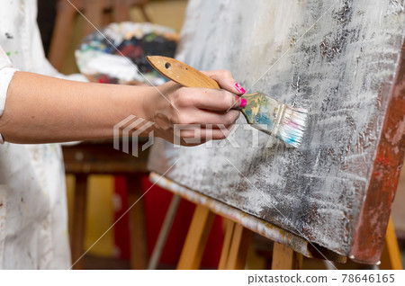 Close-up of an unrecognizable woman painter doing a brush stroke Close-up of an unrecognizable woman painter doing a brush stroke 78646165