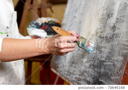 Close-up of an unrecognizable woman painter doing a brush stroke 78646166