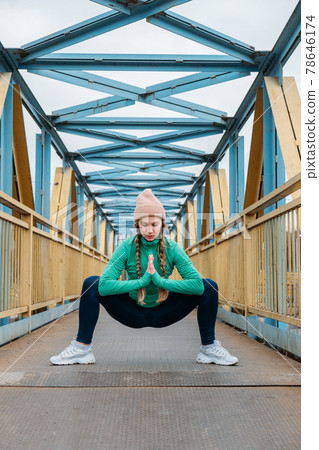 Young woman stretches during workout, fit girl exercising and doing stretching exercise in park. Sportswoman making stretch exercises before running workout Young woman stretches during workout, fit girl exercising and doing stretching exercise in park. Sportswoman making stretch exercises before running workout 78646174