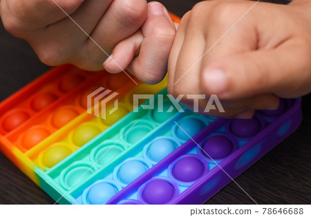 Children hands are competing for the speed of clicking on a color pop it 78646688