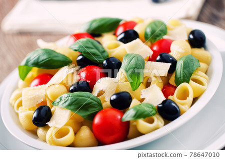 Fresh Pasta Salad with Tomatoes and Black Olives. High quality photo Fresh Pasta Salad with Tomatoes and Black Olives. High quality photo 78647010