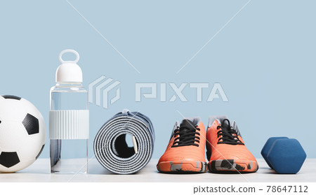 Rolled yoga mat and sport shoes with soccer ball Rolled yoga mat and sport shoes with soccer ball 78647112