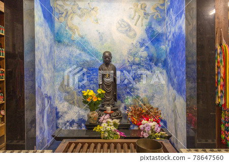 Small figure of buddha with flowers, Hanibe caves, Japan. Small figure of buddha with flowers, Hanibe caves, Japan. 78647560