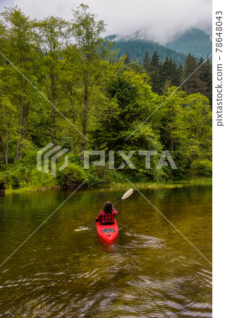 Adventure Caucasian Adult Woman Kayaking in Red Kayak Adventure Caucasian Adult Woman Kayaking in Red Kayak 78648043