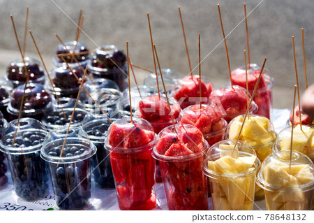 Street vendor of various fruits cut into transparent plastic cups Street vendor of various fruits cut into transparent plastic cups 78648132