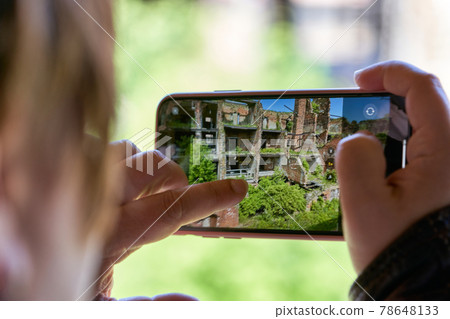 Taking a photo on a smartphone while traveling. Fortress Oreshek Taking a photo on a smartphone while traveling. Fortress Oreshek 78648133