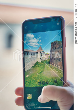 Taking a photo on a smartphone while traveling. Fortress Oreshek Taking a photo on a smartphone while traveling. Fortress Oreshek 78648134