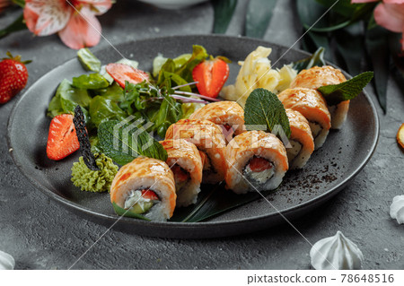 Maki Sushi - a roll of cream cheese, strawberries, avocado and fried salmon. Summer seasonal sushi rolls Maki Sushi - a roll of cream cheese, strawberries, avocado and fried salmon. Summer seasonal sushi rolls 78648516