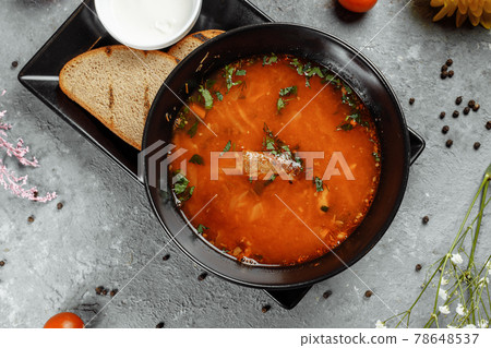 Traditional Ukrainian Russian borscht with white beans on the black bowl. Flat lay. Top view 78648537