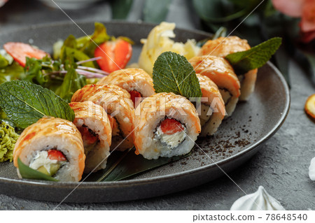 Maki Sushi - a roll of cream cheese, strawberries, avocado and fried salmon. Summer seasonal sushi rolls Maki Sushi - a roll of cream cheese, strawberries, avocado and fried salmon. Summer seasonal sushi rolls 78648540