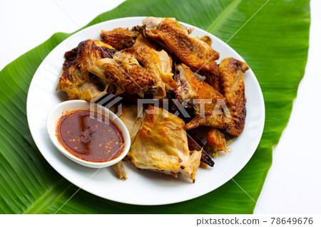 Grilled chicken, Thai style food on banana leaf Grilled chicken, Thai style food on banana leaf 78649676